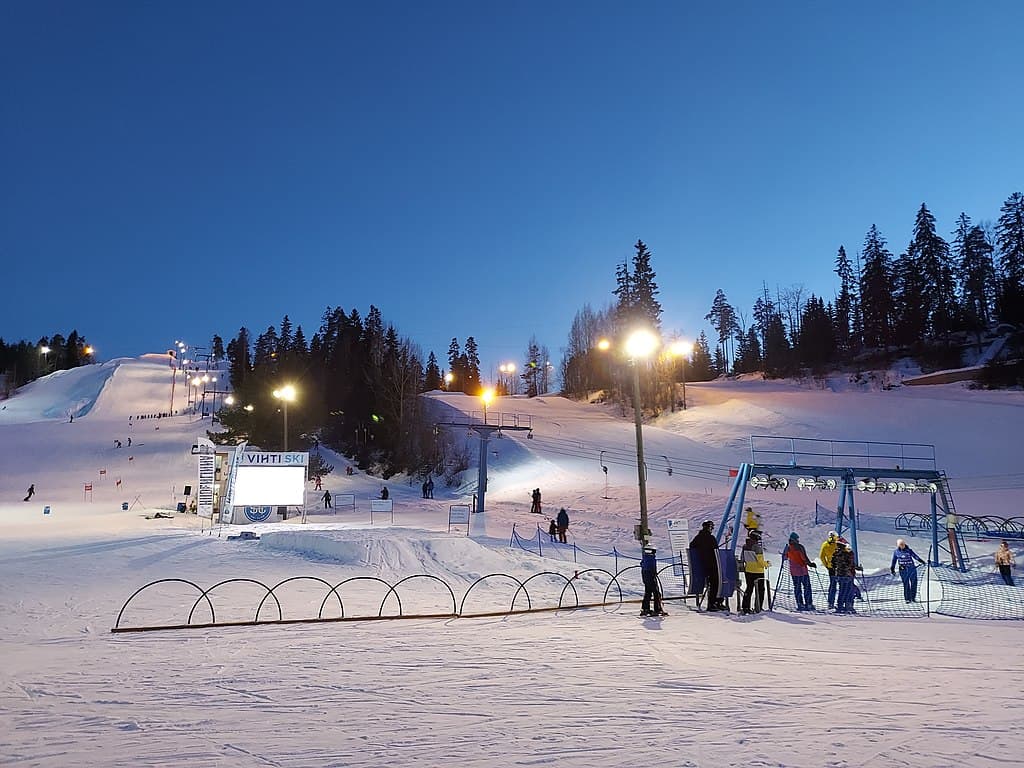 Vihti Ski Center in Finland - a group of people standing on top of a ski slope.