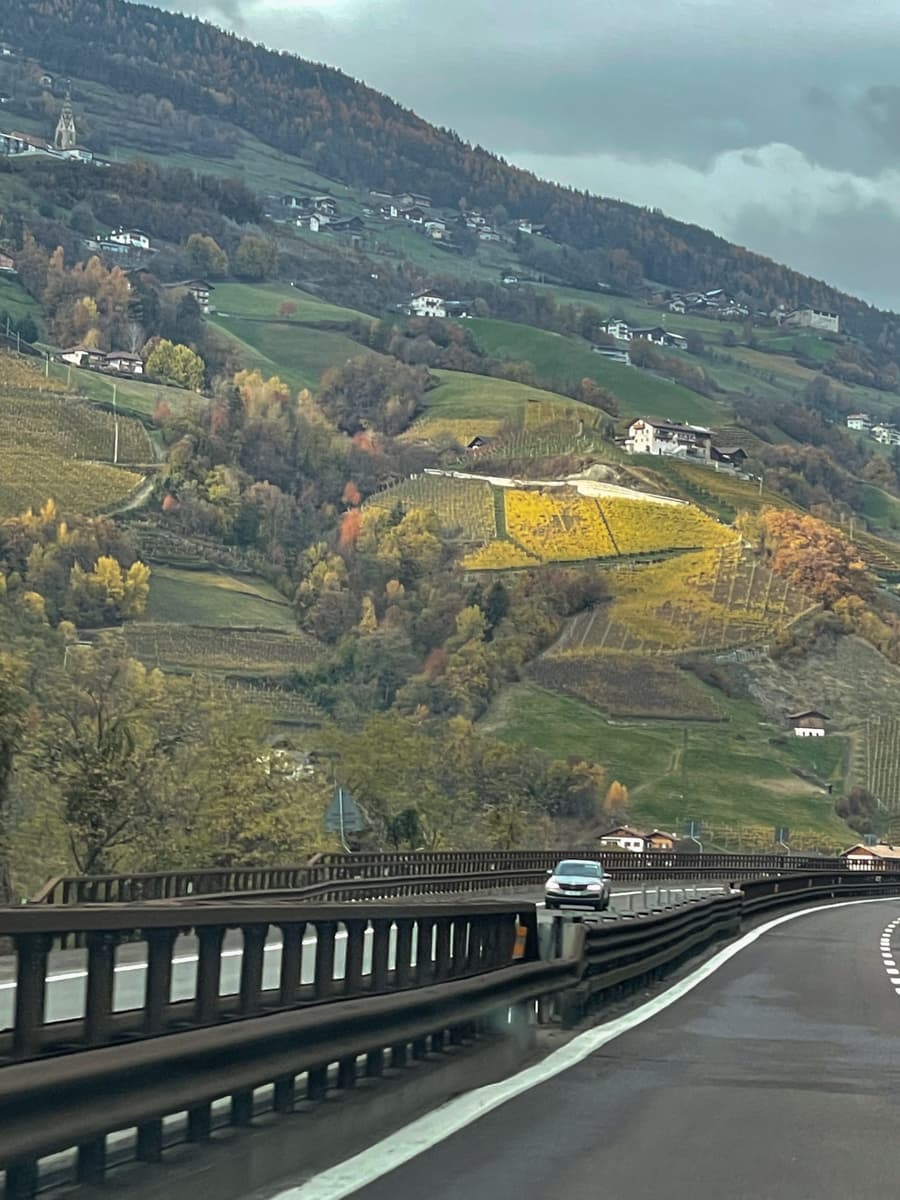 Sulden in Italy - a car driving down a road with hills in the background.