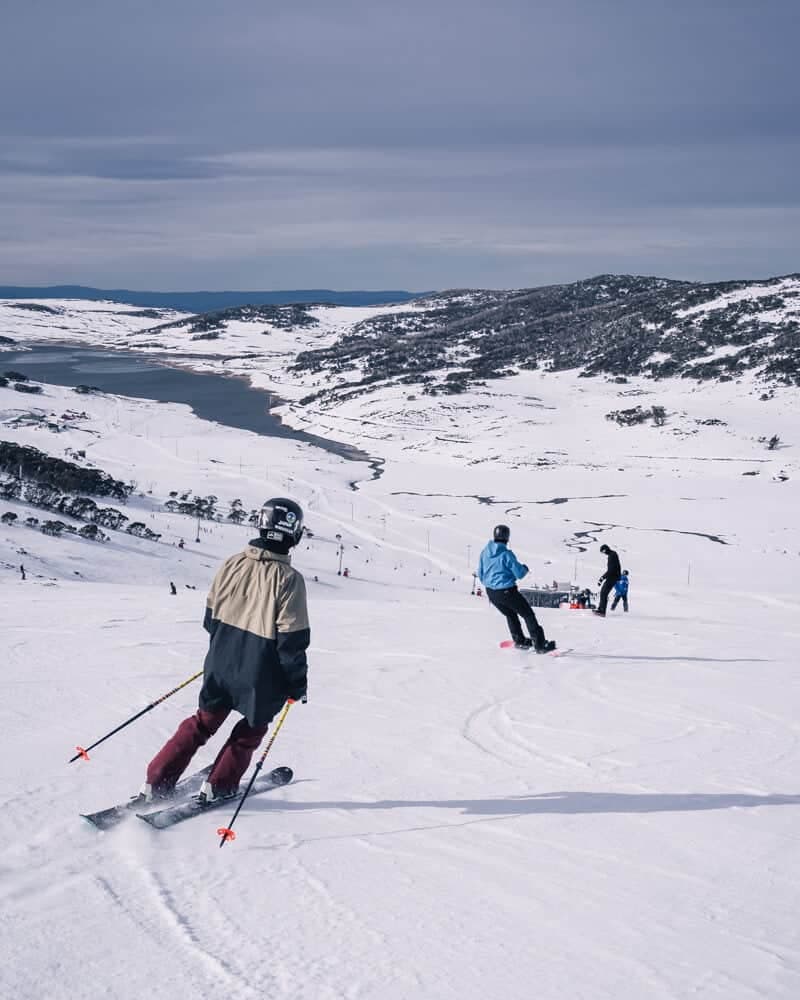 Falls Creek in Australia - a group of people skiing down a snowy slope.