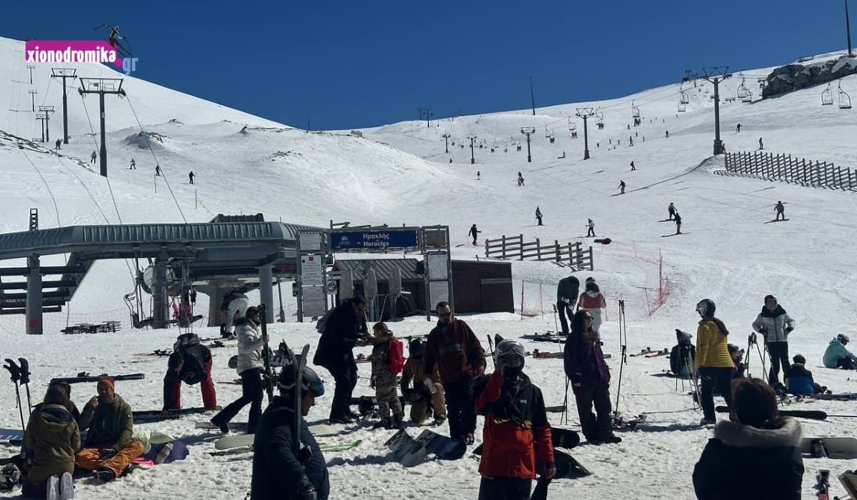 Lailia in Greece - a group of people standing on top of a snow covered slope.