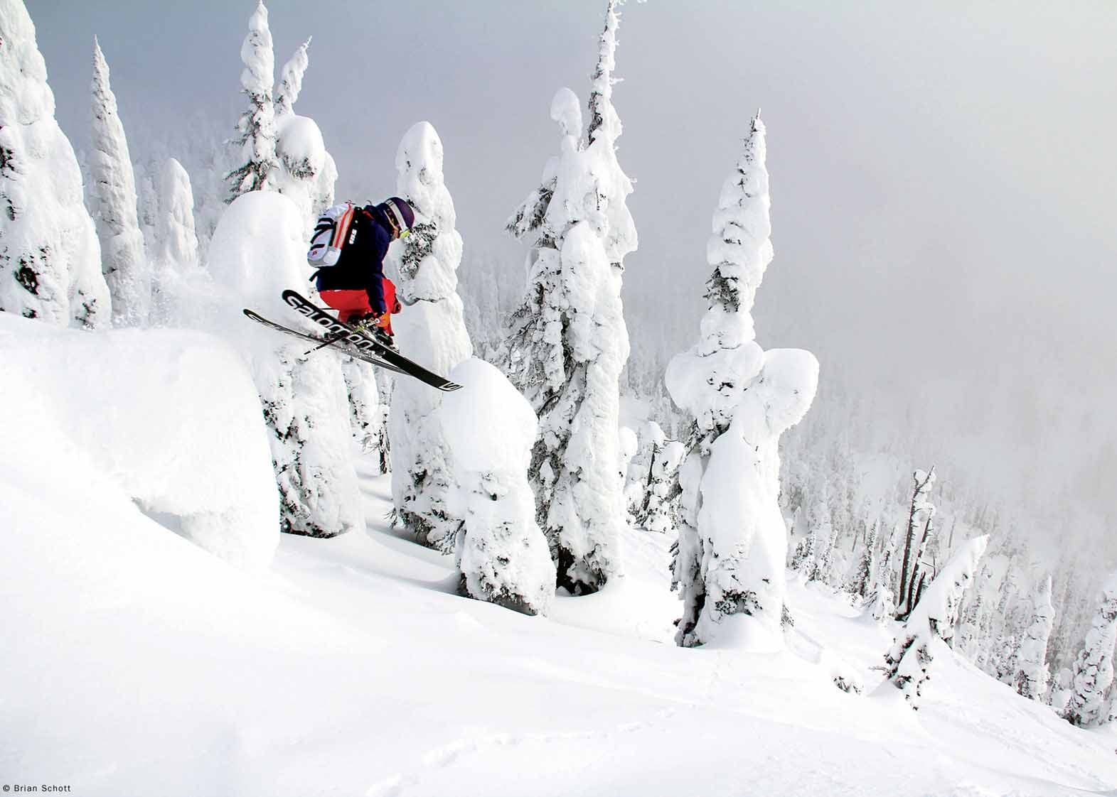 Whitefish Mountain Resort in USA - a person jumping in the air on a snowboard.