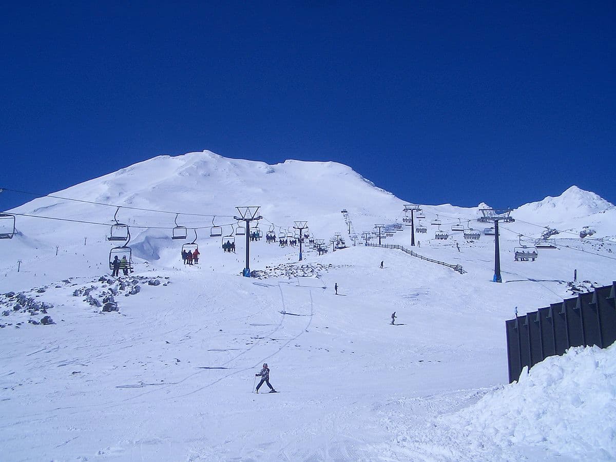 Turoa Mt Ruapehu in New Zealand - a group of people skiing down a snowy hill.