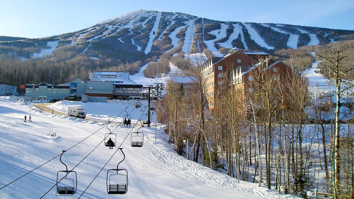 Sugarloaf Mountain in USA - a ski lift going up a snowy hill.
