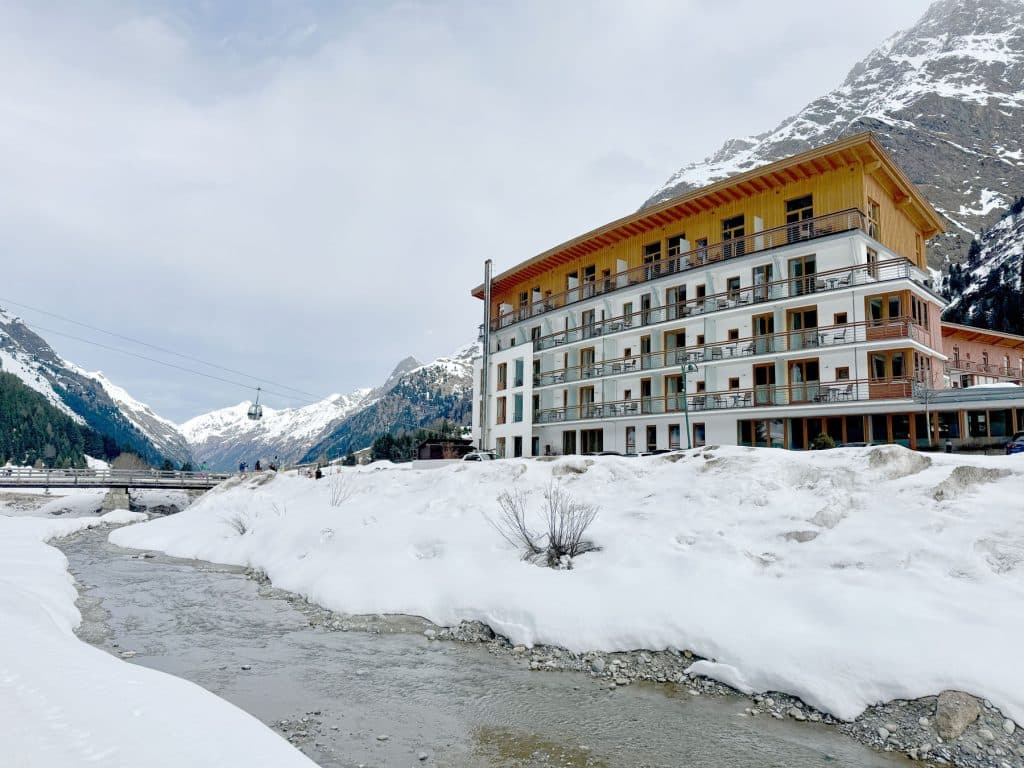 Rifflsee in Austria - a river running through a snow covered area.