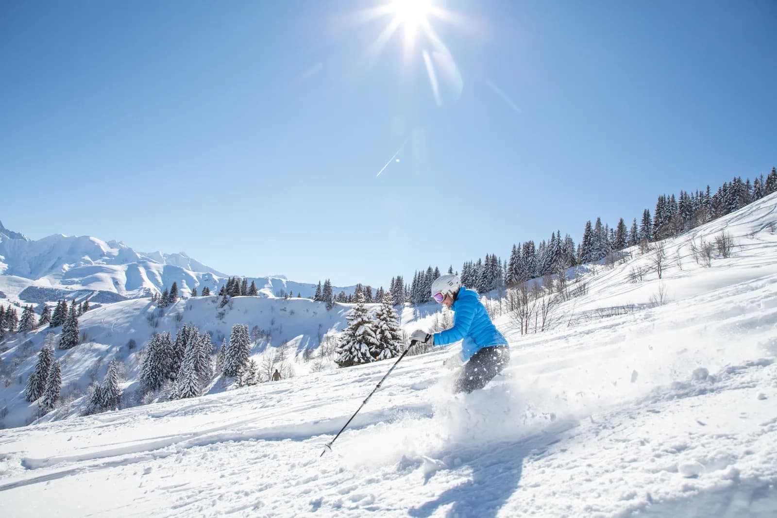 Les Portes du Mont-Blanc in France - a person skiing down a snow covered mountain.