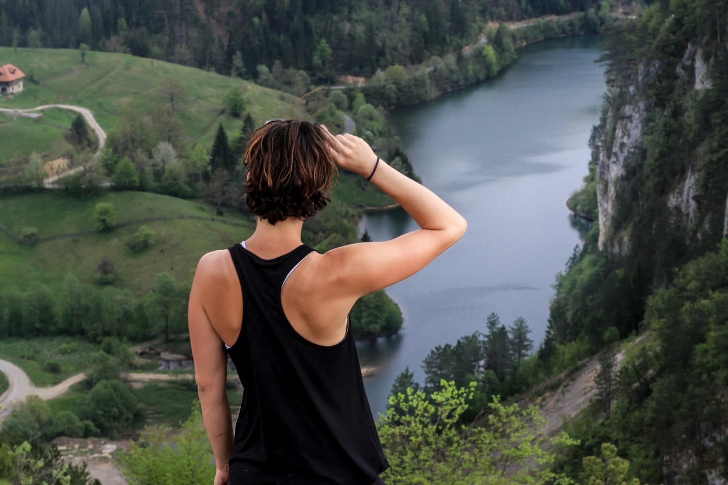 Beli Bor in Serbia - a woman standing on a cliff overlooking a lake.