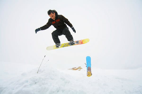 A snowboarder gliding down the snow-covered slopes of Matroosberg in the Western Cape, South Africa.