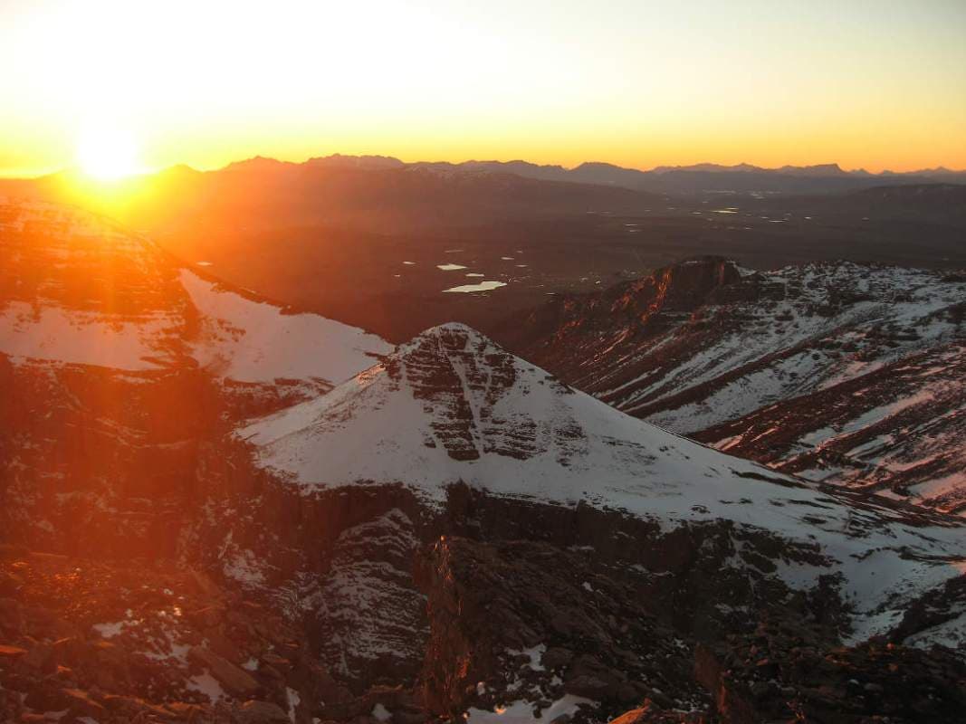 Snow-capped Matroosberg mountain in Western Cape, South Africa featuring a winter sports scene and a charming challet amidst breathtaking winter scenery.
