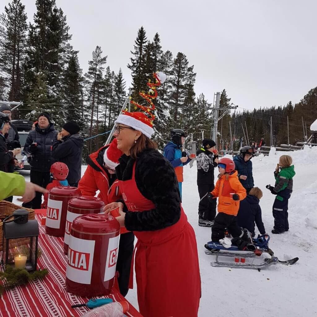 Höglekardalen in Sweden - a group of people standing around a red and white table.