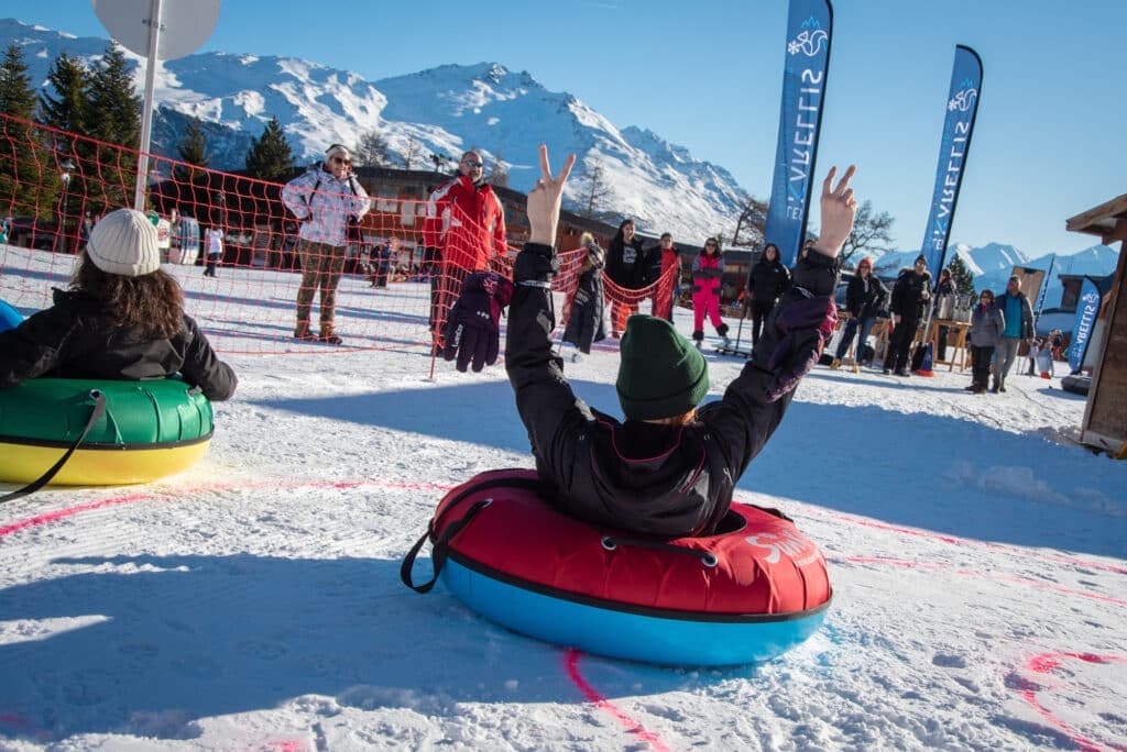 Skier and snowboarder enjoying the winter sports scene at Karellis ski resort in Savoie Mont Blanc amidst snowy alpine landscape in Montricher-Albanne France.