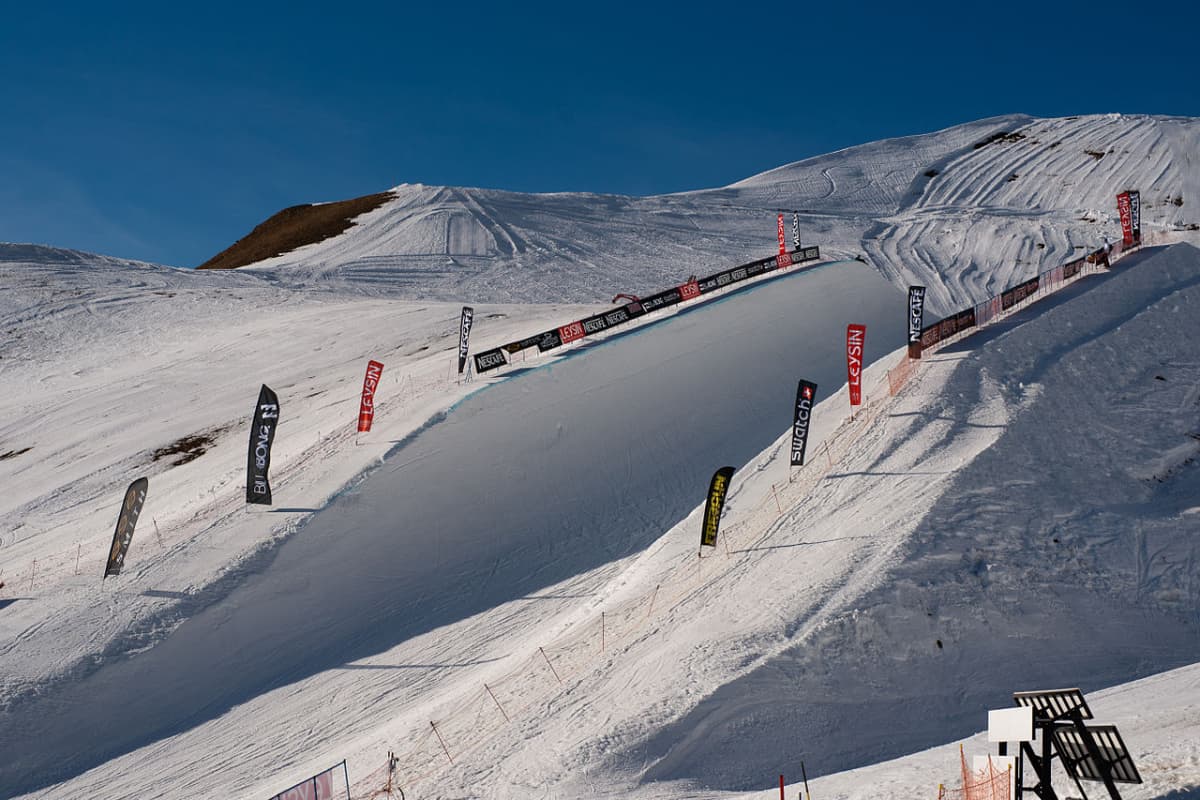 Leysin in Switzerland - a group of people riding down a snow covered slope.