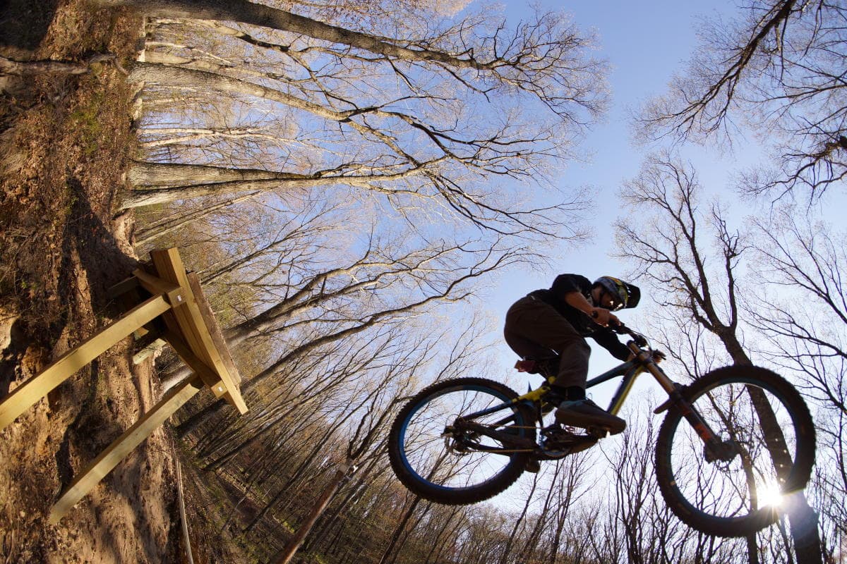 Pinehurst Park – Eau Claire in USA - a man riding a bike up the side of a tree.