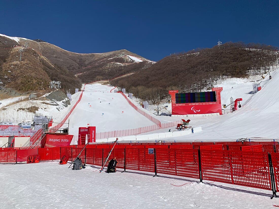Yanqing National Alpine Ski Centre in China - a red fence in the snow.