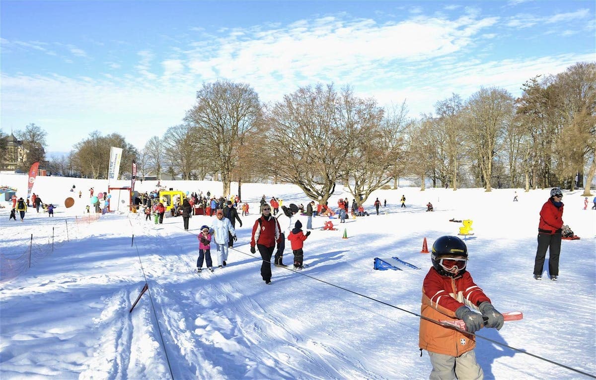 Goldiwil – Multenegg in Switzerland - a group of people skiing down a hill.