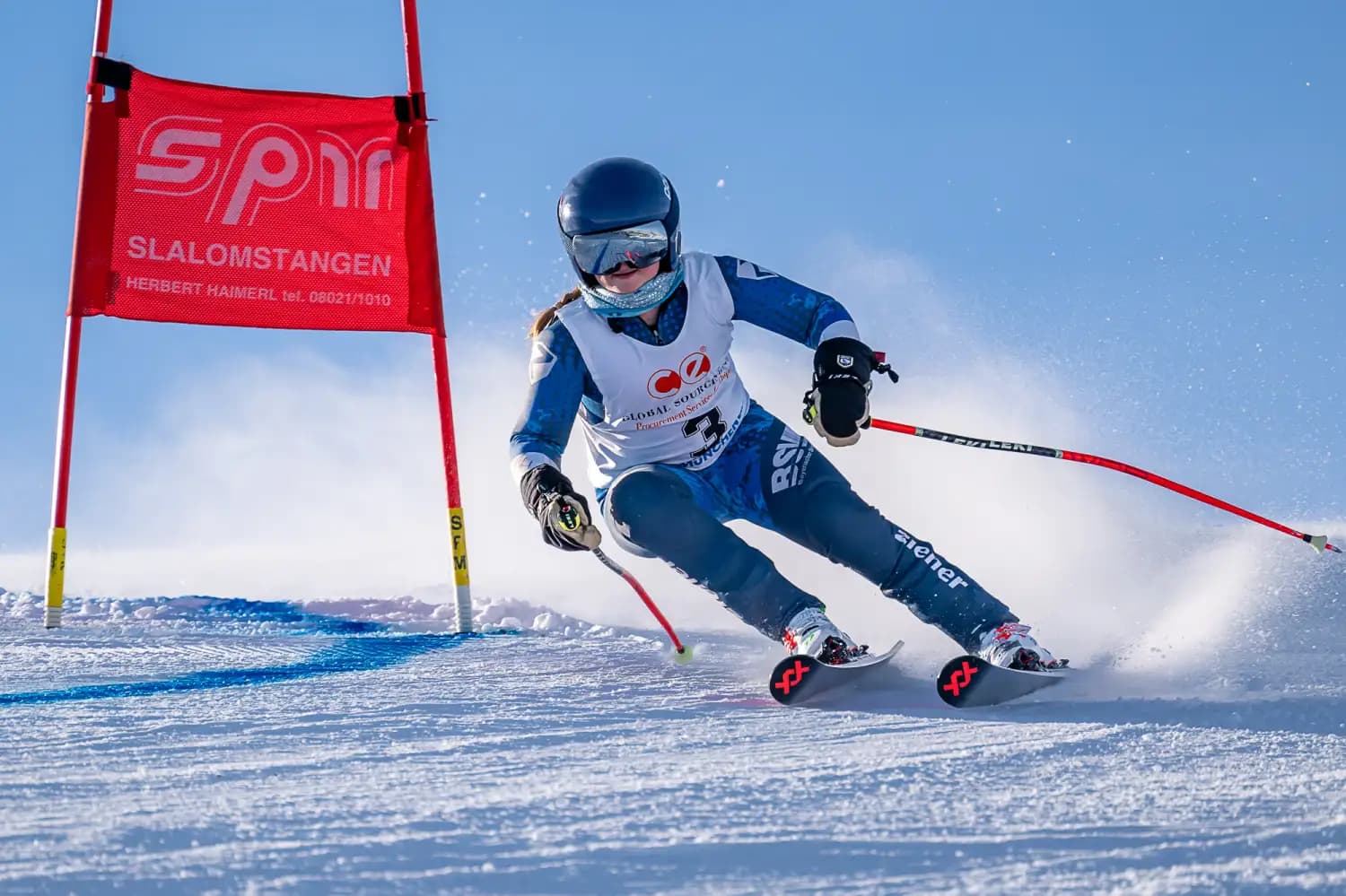 Mattnerhalde – Prem in Germany - a skier skiing down a slope with a red flag.