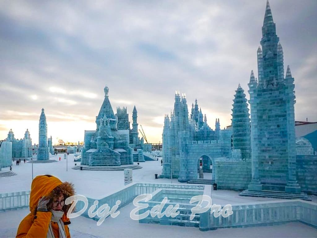 Taihu Longemont Snow World in China - a person in a yellow jacket standing in front of ice sculptures.