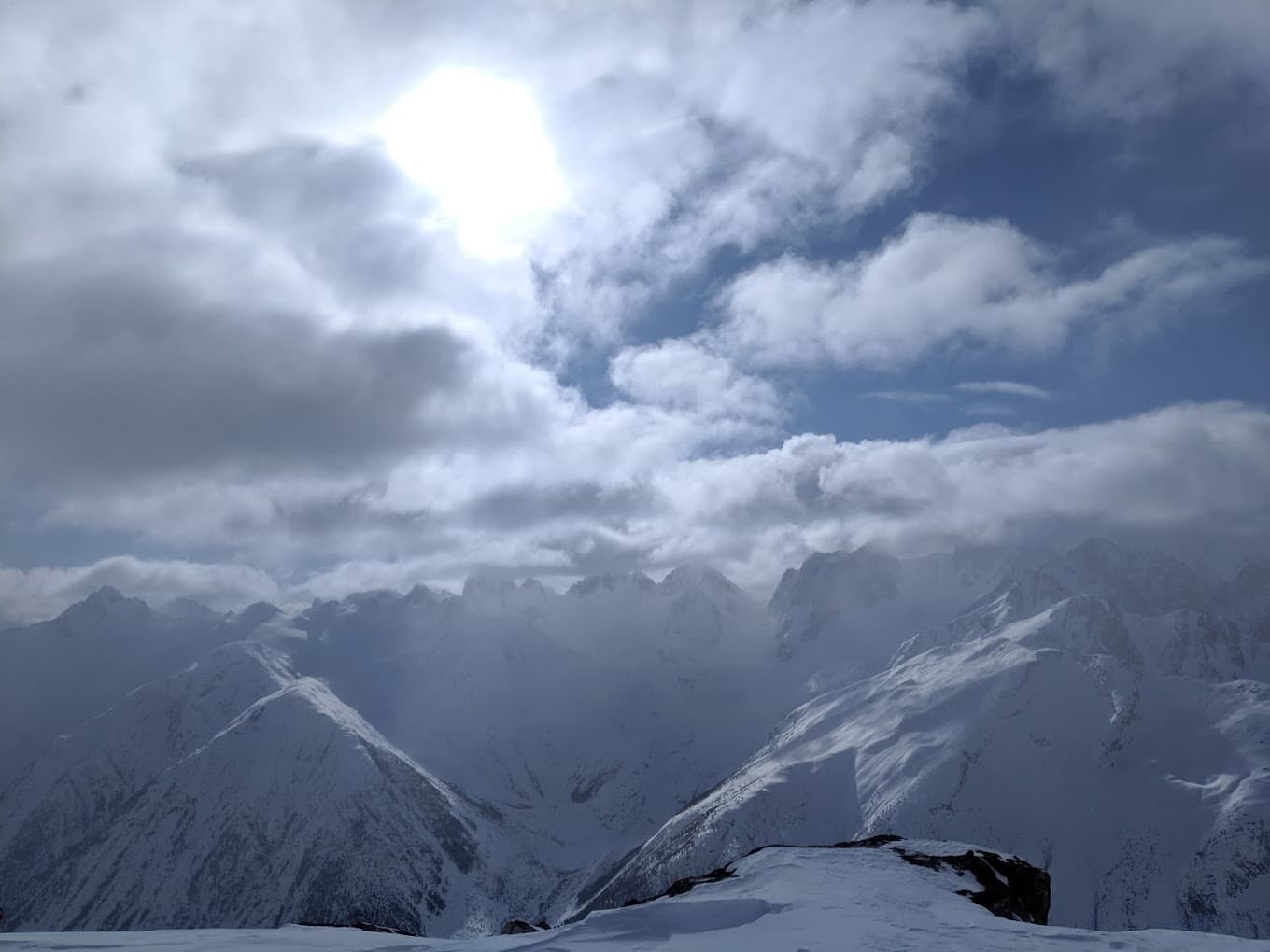 In this breathtaking winter scene from Pantheon in British Columbia a stunning snowy mountain range complete with a cosy chalet forms the backdrop for a vibrant winter sports scene.