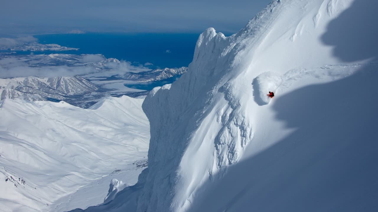 Kamchatka in Russia - a man climbing up the side of a mountain.