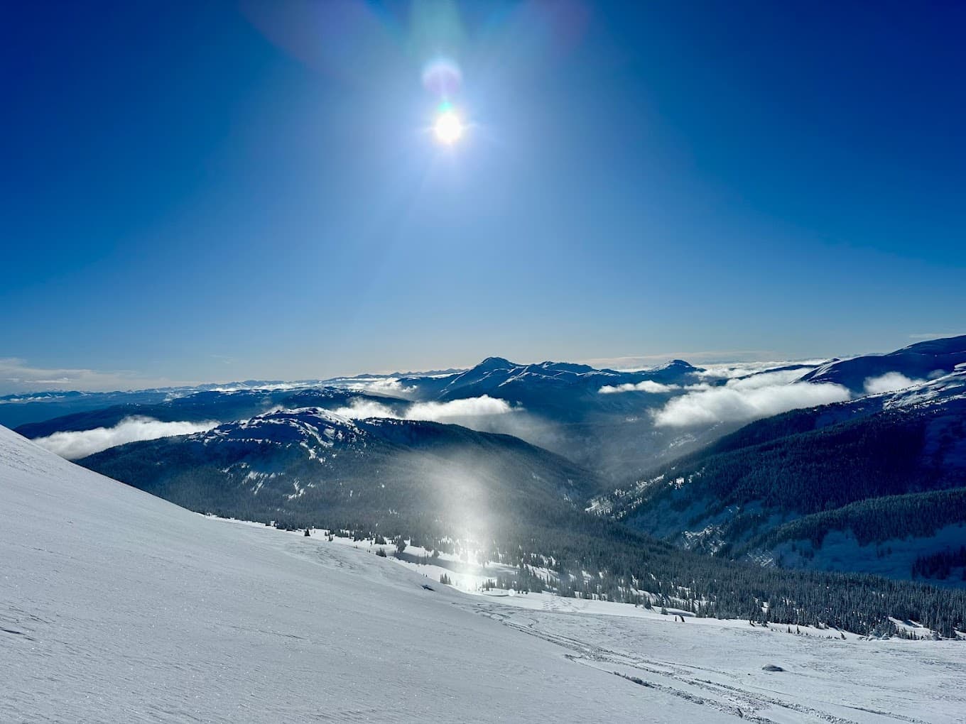 A skier swiftly descends a mountain at Skeena Heliskiing Resort in Northern British Columbia, Canada, with a charming chalet seen nearby. A delightful winter sports scene in the majestic Canadian wilderness.