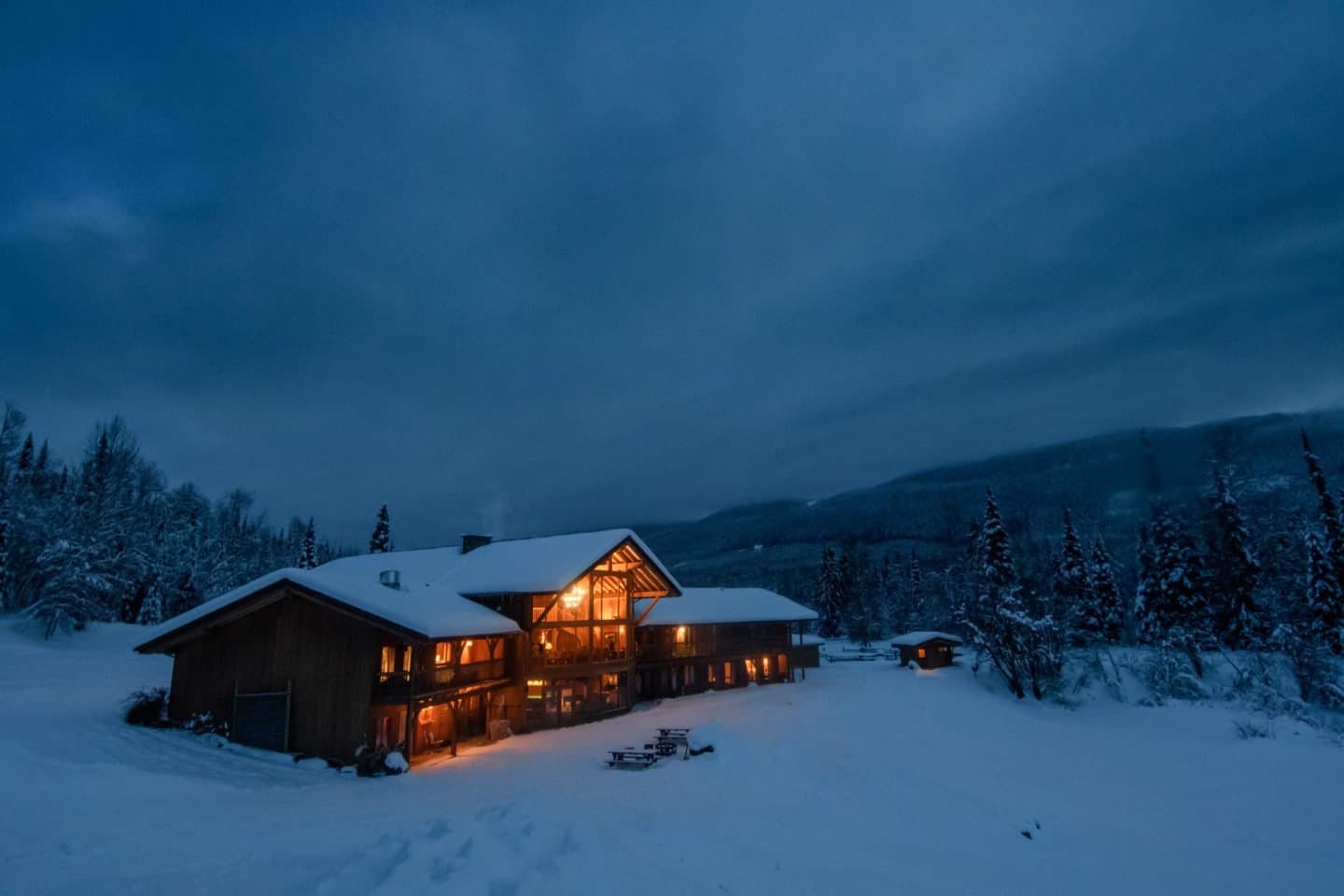 Skeena Heliskiing in Canada - a cabin in the snow at night.