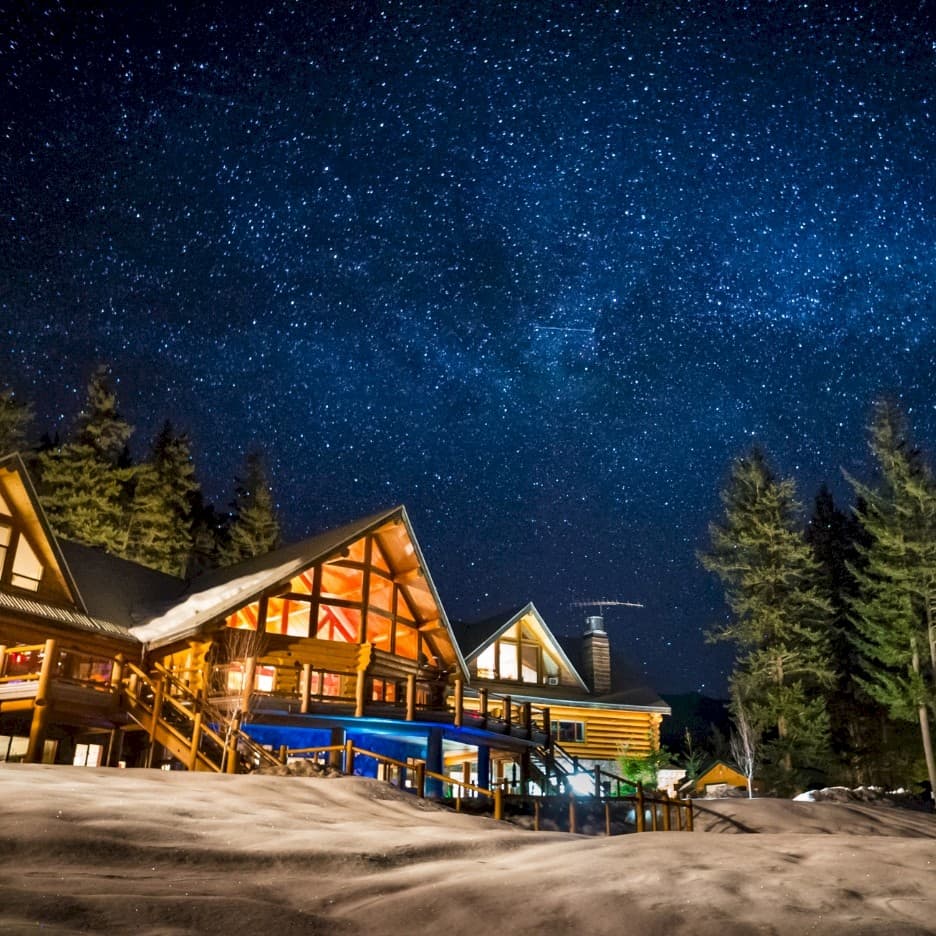 Tyax Heliskiing in Canada - a cabin at night with the stars above.