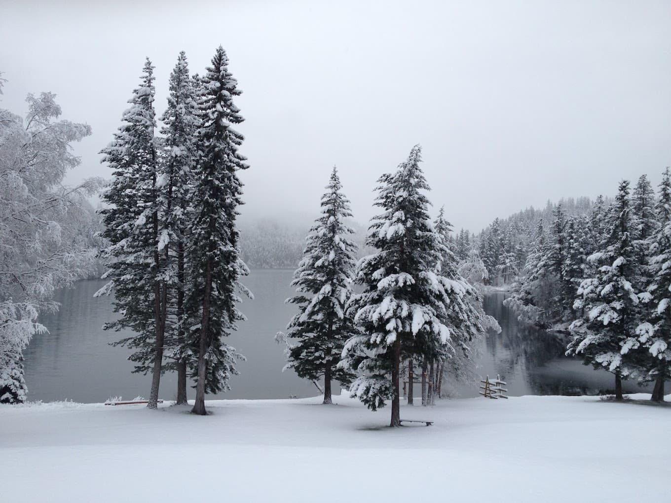Breathtaking winter panorama at Tyax Heliskiing in Vancouver, featuring a pristine snowy landscape with lake views, notable as a destination for winter sports.