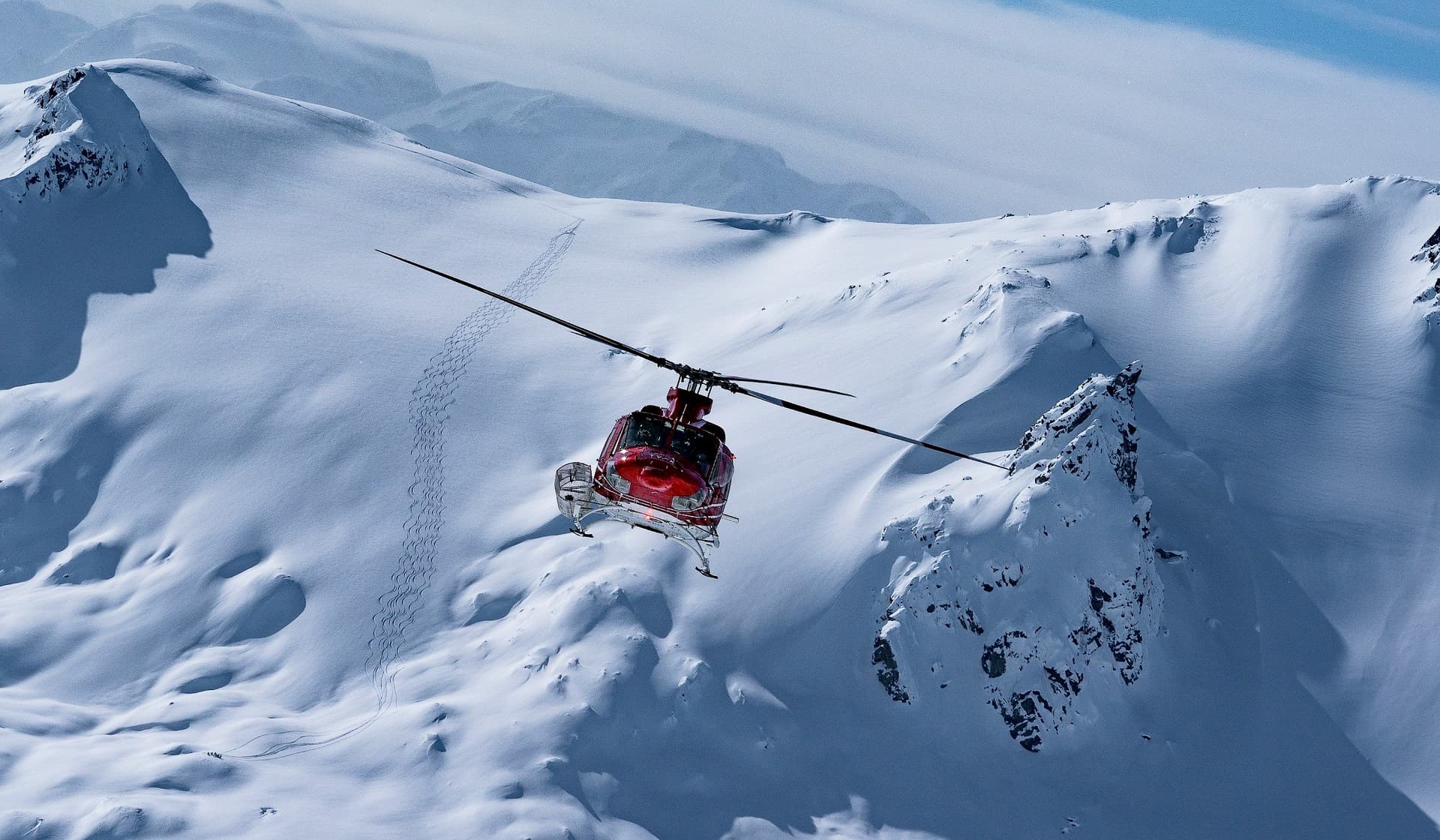 A skier tackling a powdery slope in Tyax Heliskiing, Vancouver, surrounded by the stunning beauty of a winter sports scene in snowy British Columbia, Canada.