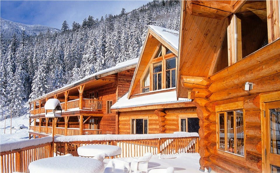 Scenic view of Tyax Heliskiing resort in British Columbia, featuring a cozy lodge nestled in a breathtaking winter landscape, perfect for winter sports enthusiasts.