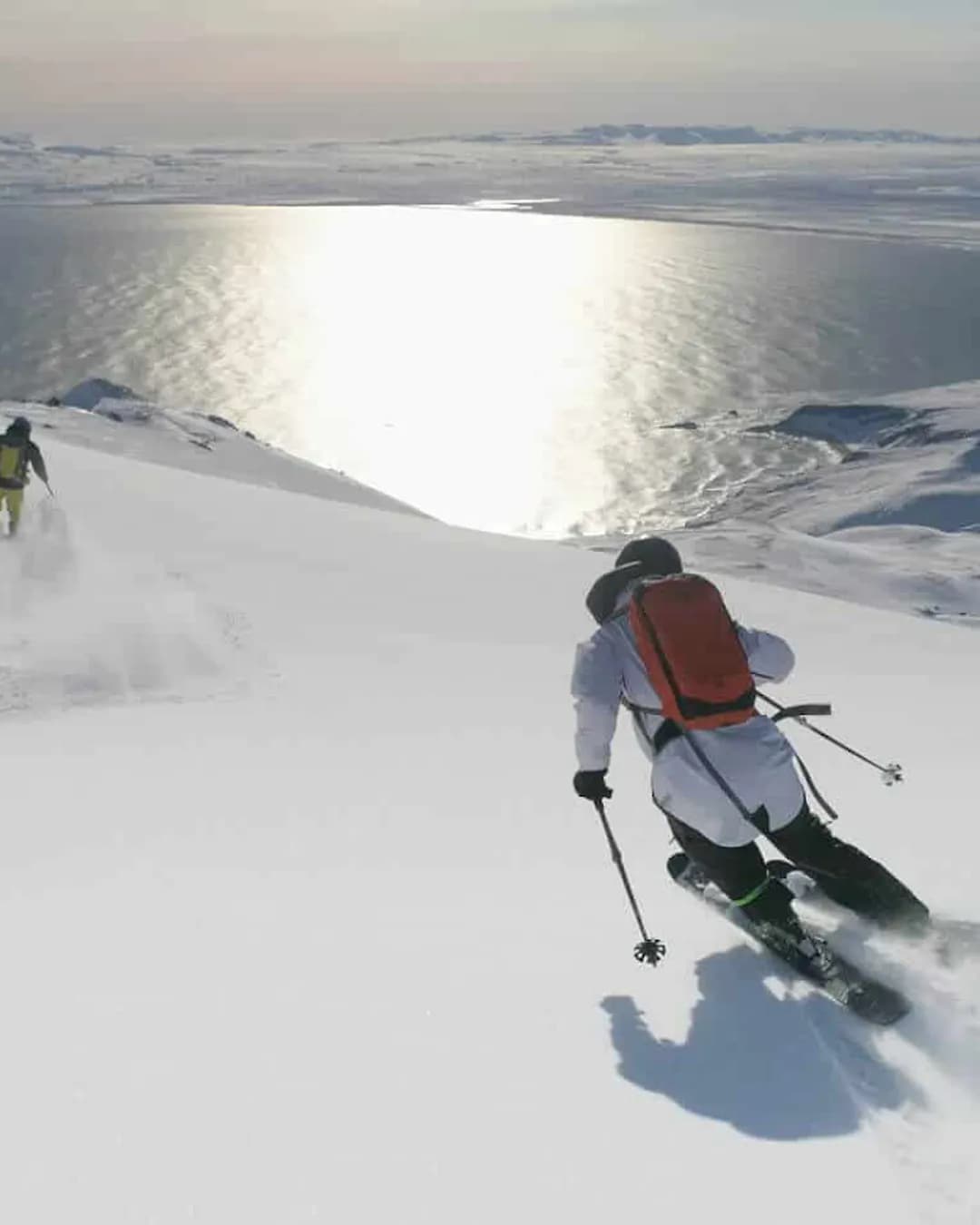 Víking Heliskiing in Iceland - two skiers are skiing down a snowy slope.