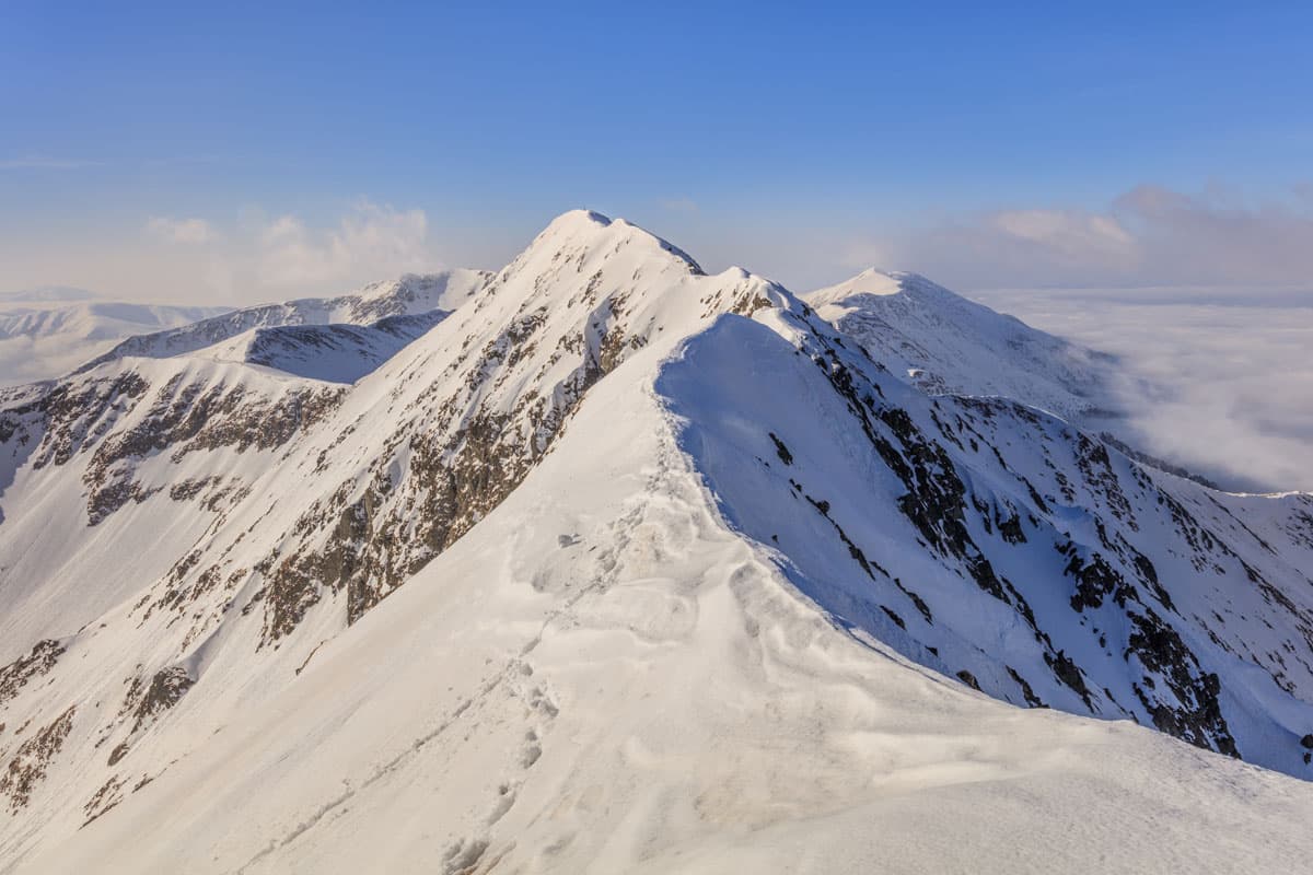 Vârful lui Roman in Romania - a snow covered mountain.