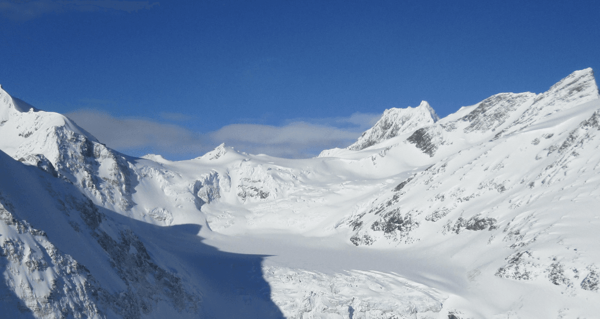 Valemount Glaciers in Canada - a group of people skiing down a snowy mountain.