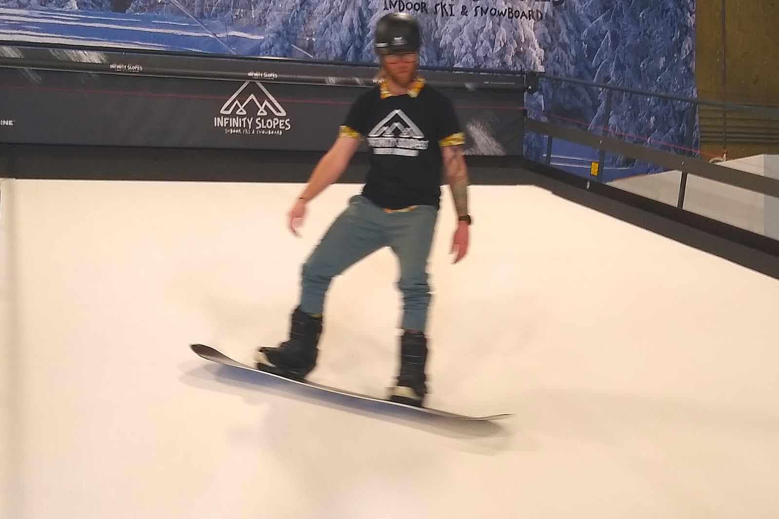 Infinity Slopes – Loveland in USA - a man riding a snowboard down a ramp.