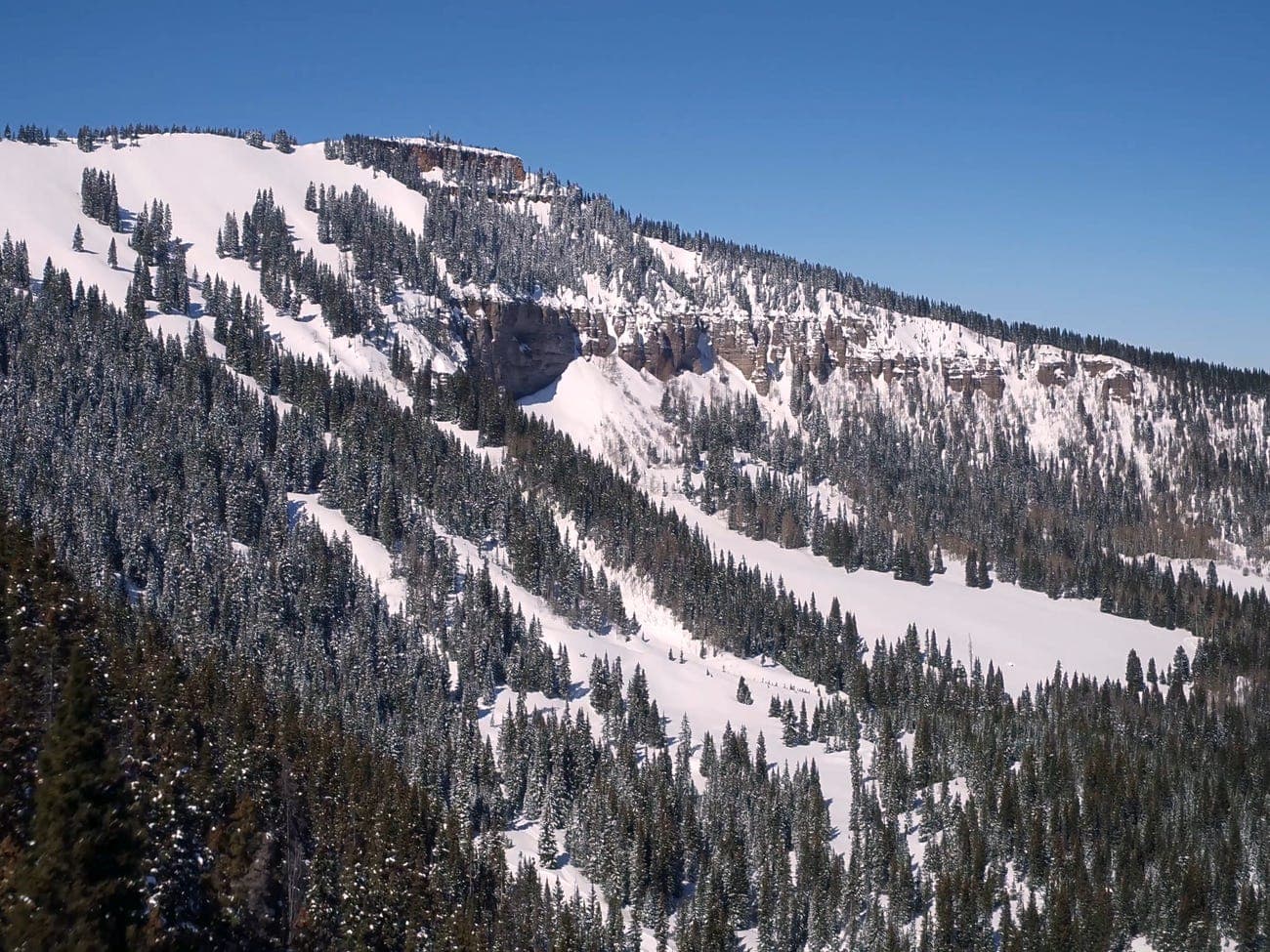 Winter scene at Cimarron Mountain Club in Colorado, USA featuring snow-covered slopes, and a mountain, reflecting an ambiance of a ski resort.