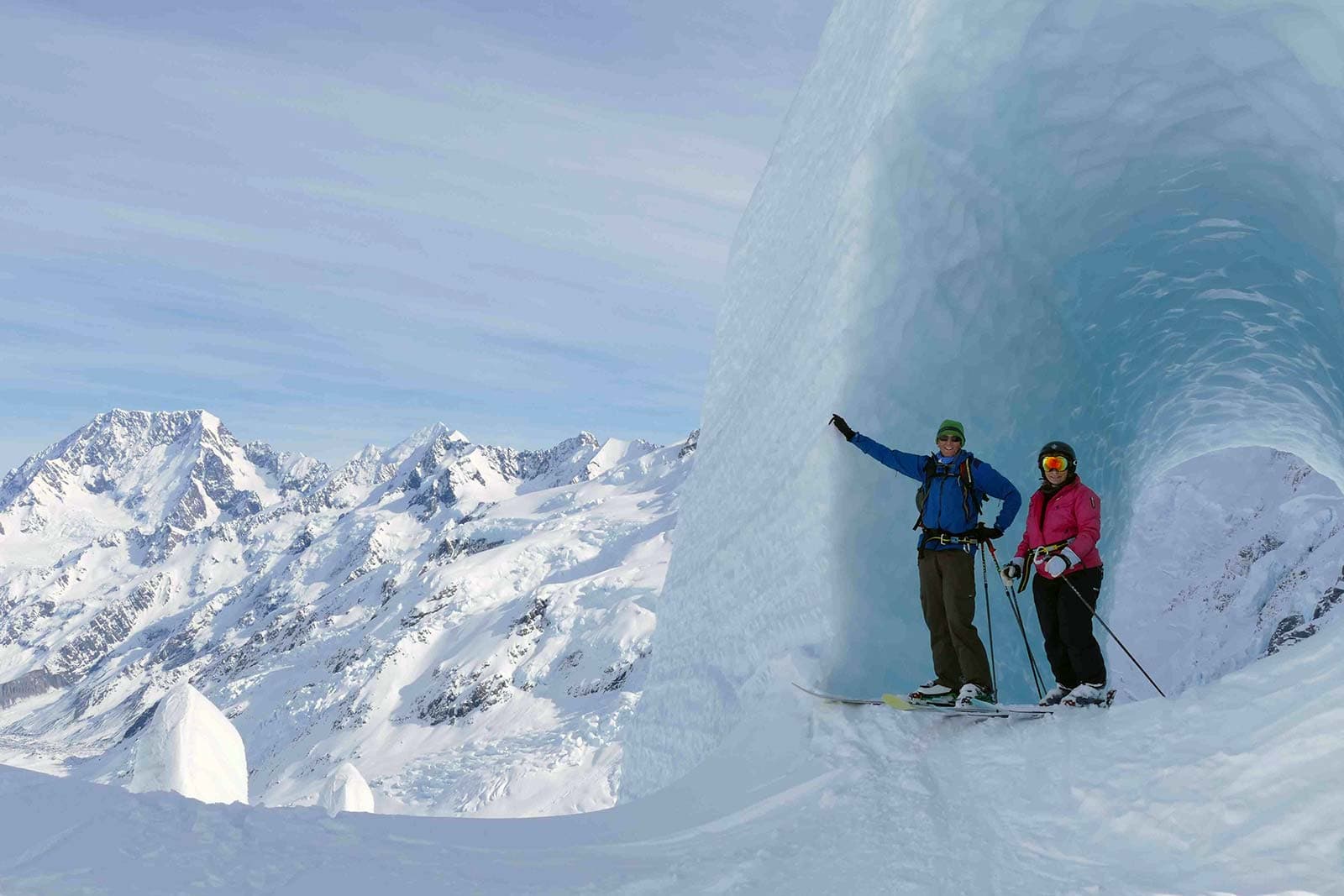 Tasman Glacier in New Zealand - a man and a woman are skiing in the snow.