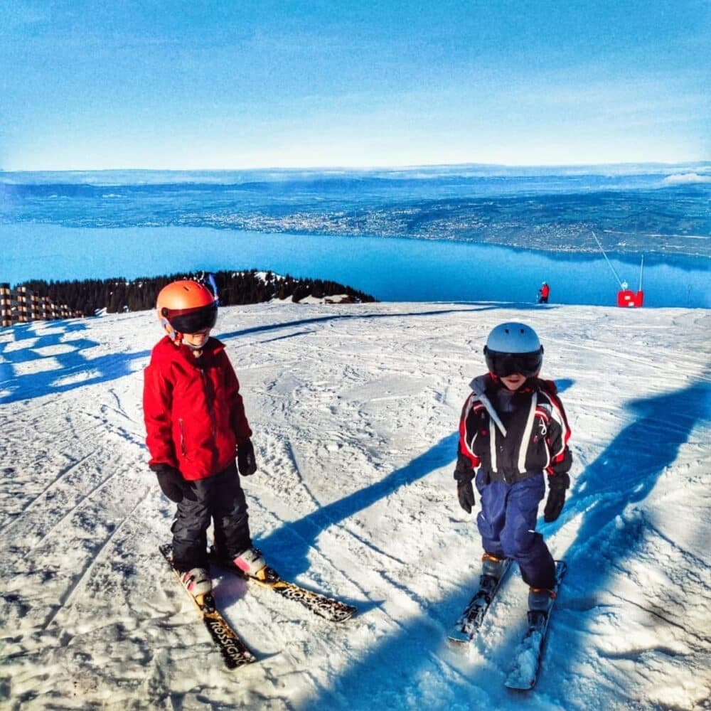 Thollon les Mémises in France - two children are skiing on a snowy mountain.