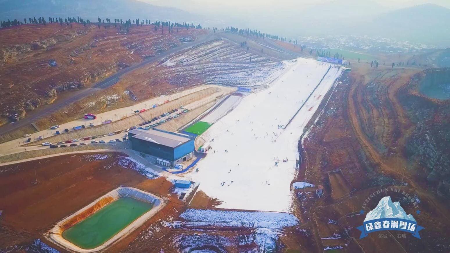 Lvxinchun in China - an aerial view of a construction site in the mountains.