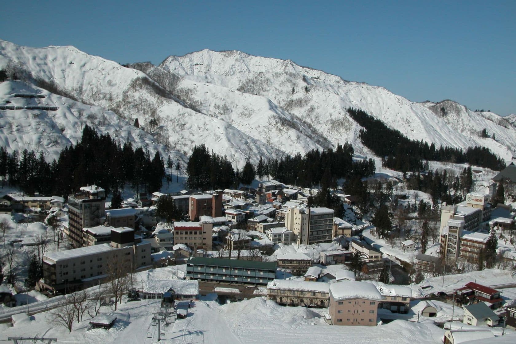 Oyu Onsen in Japan - snow covered mountains in the background.