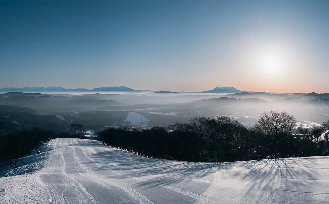 Shirotori Snow Resort in Japan - the sun is shining over the snow covered mountains.