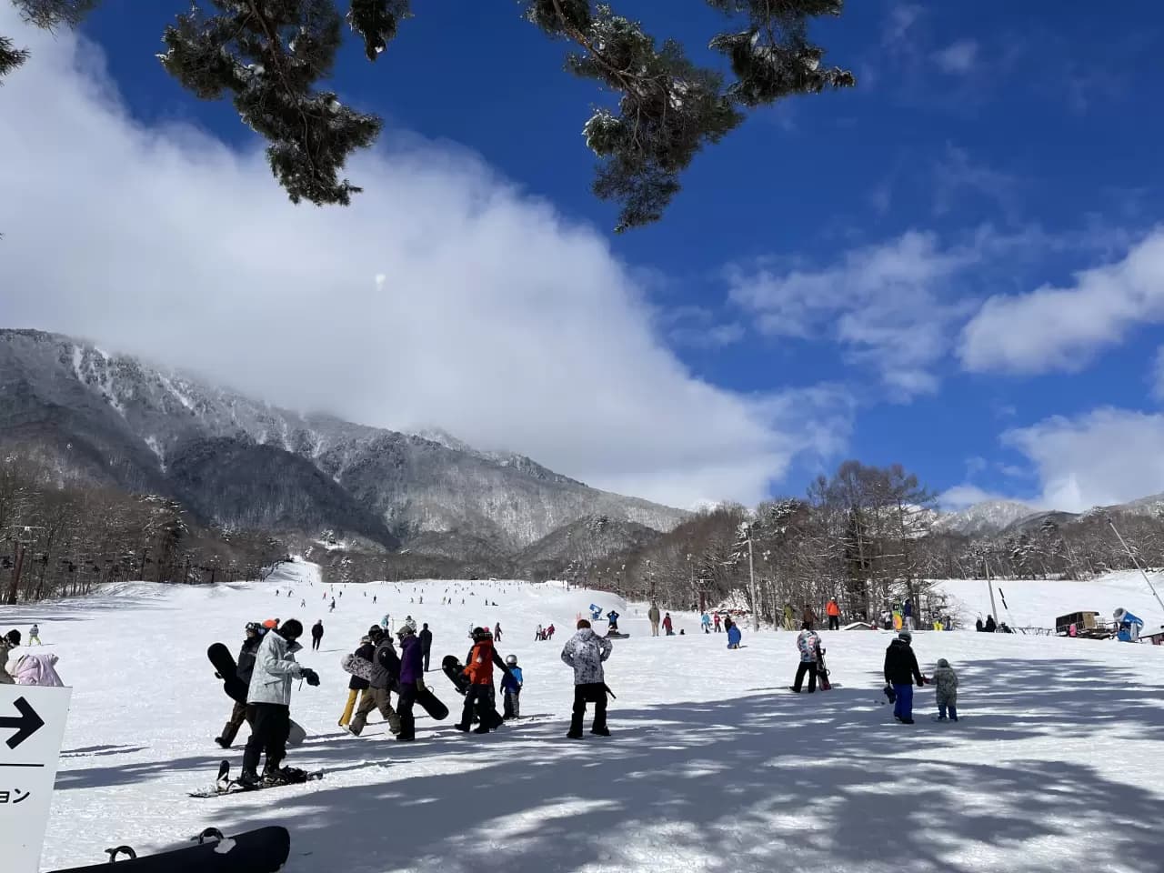 Nikko Yumoto in Japan - a group of people skiing down a snow covered slope.