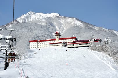 Winter scene at Waterville Valley Resort, New Hampshire, featuring the winter sports centre, ski tracks, chalet, and beautiful snowy landscape.
