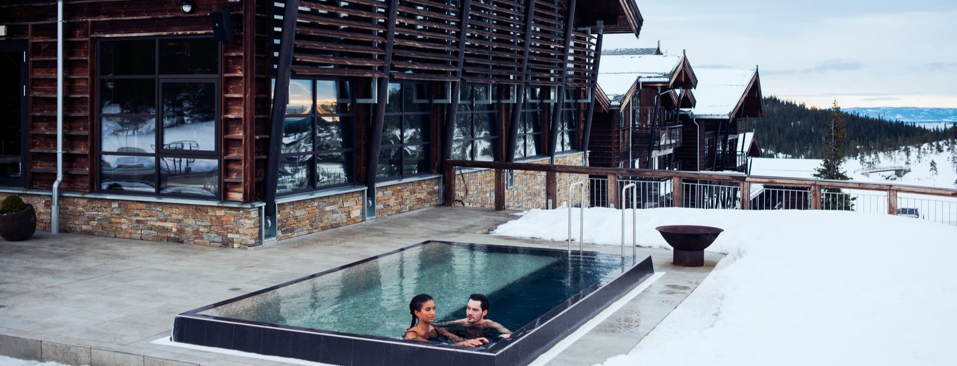 Norefjell in Norway - a woman sitting in a hot tub in the snow.