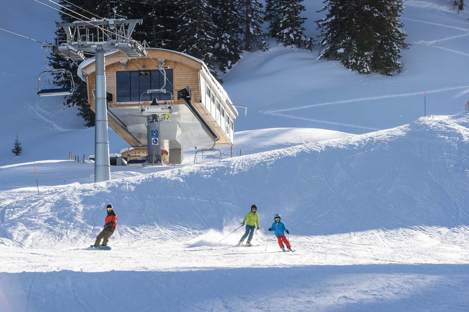 Jaun-Gastlosen Bergbahnen in Switzerland - a group of people skiing down a snowy slope.