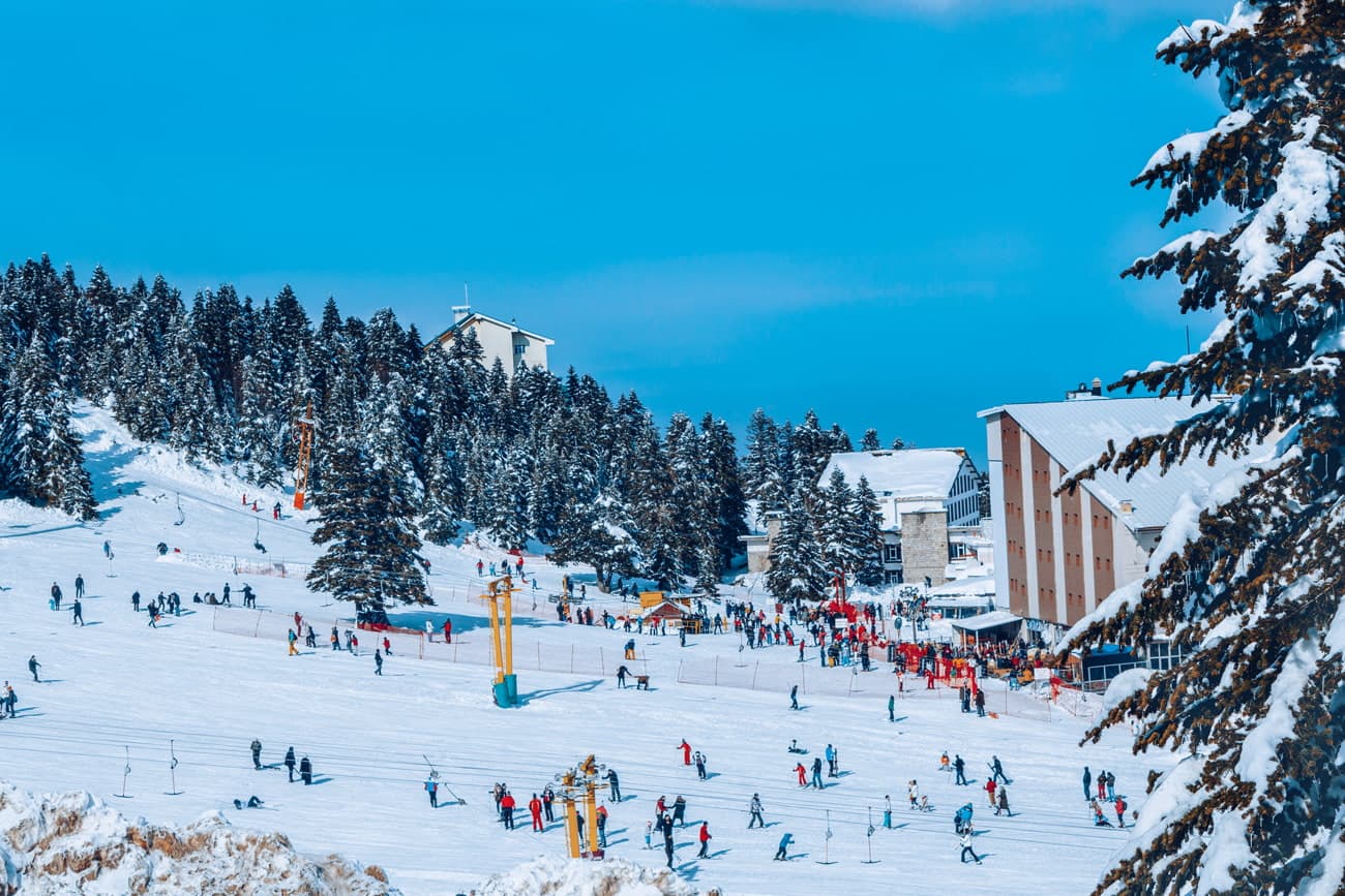 Denizli in Turkey - a group of people skiing down a snowy slope.
