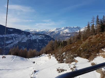 View of the Winghills Shirotori Resort in Chūbu, Japan featuring a charming chalet amidst a stunning winter scenery. The picture also highlights a winter sports scene on the mountain and ski resort.