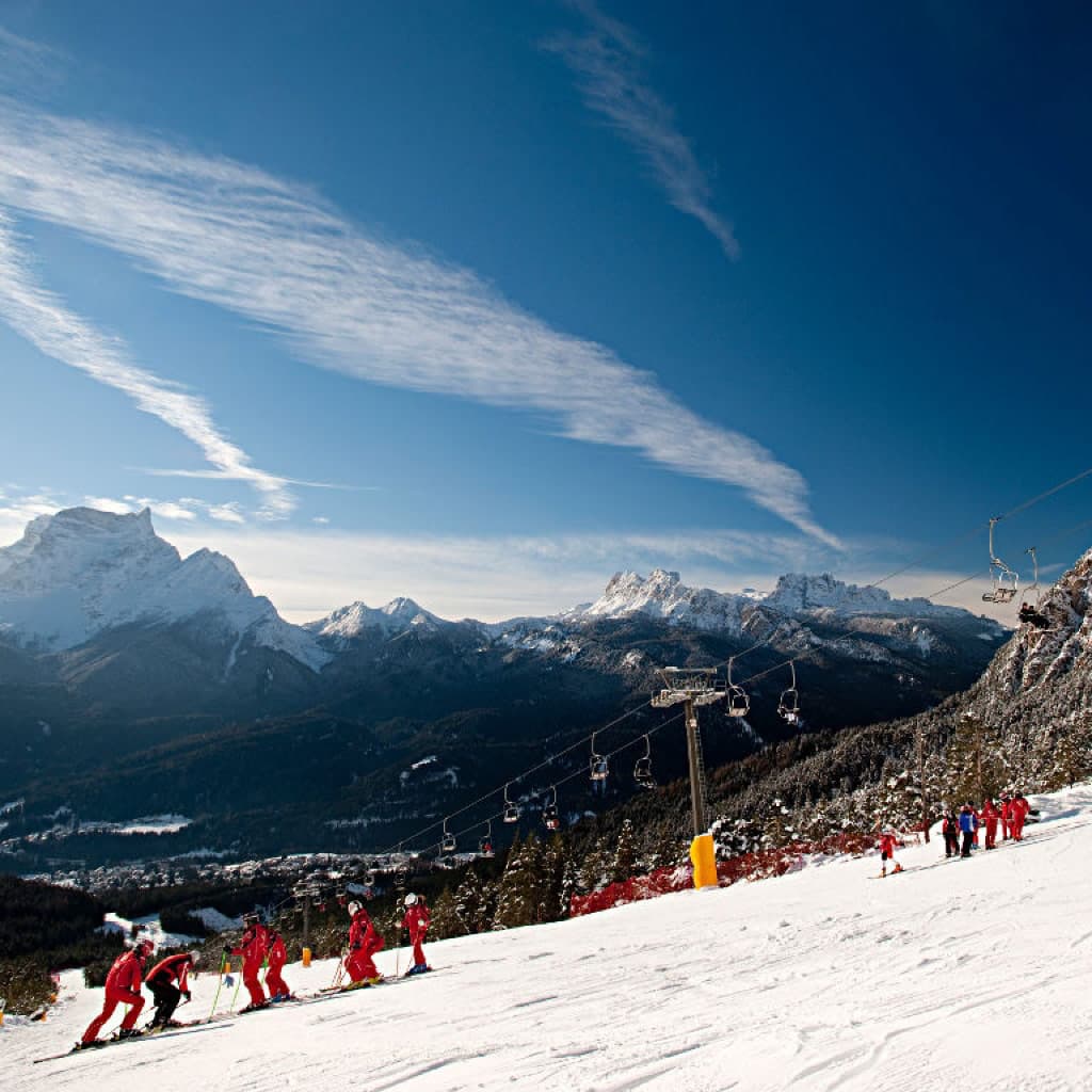 San Vito di Cadore in Italy - a group of people skiing down a mountain.