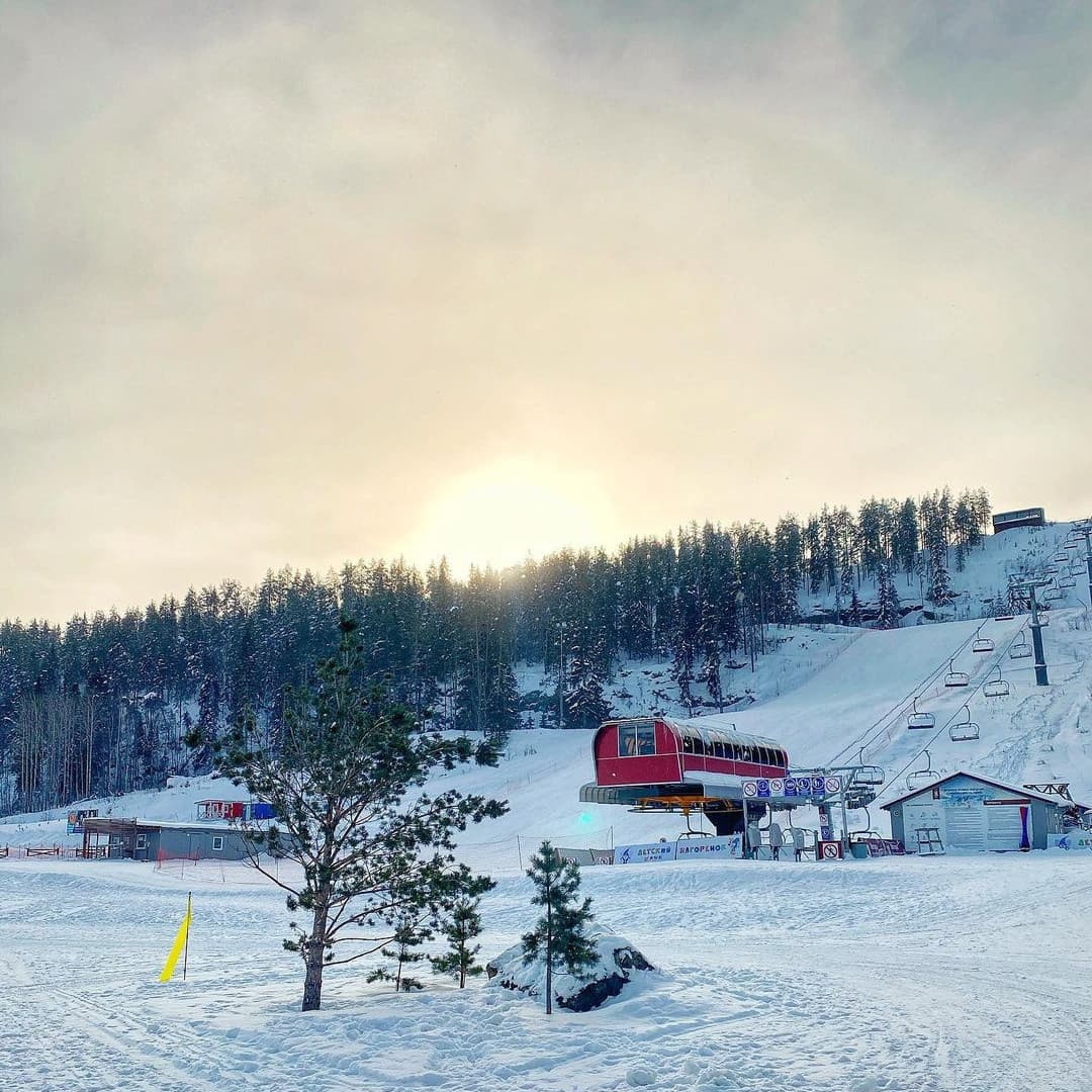 Kholdomi in Russia - a snow covered ski slope with trees in the background.