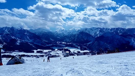 Winter sports enthusiasts enjoy skiing at Iwappara ski resort in Yuzawa, Niigata, Japan, wrapped in a stunning winter landscape.