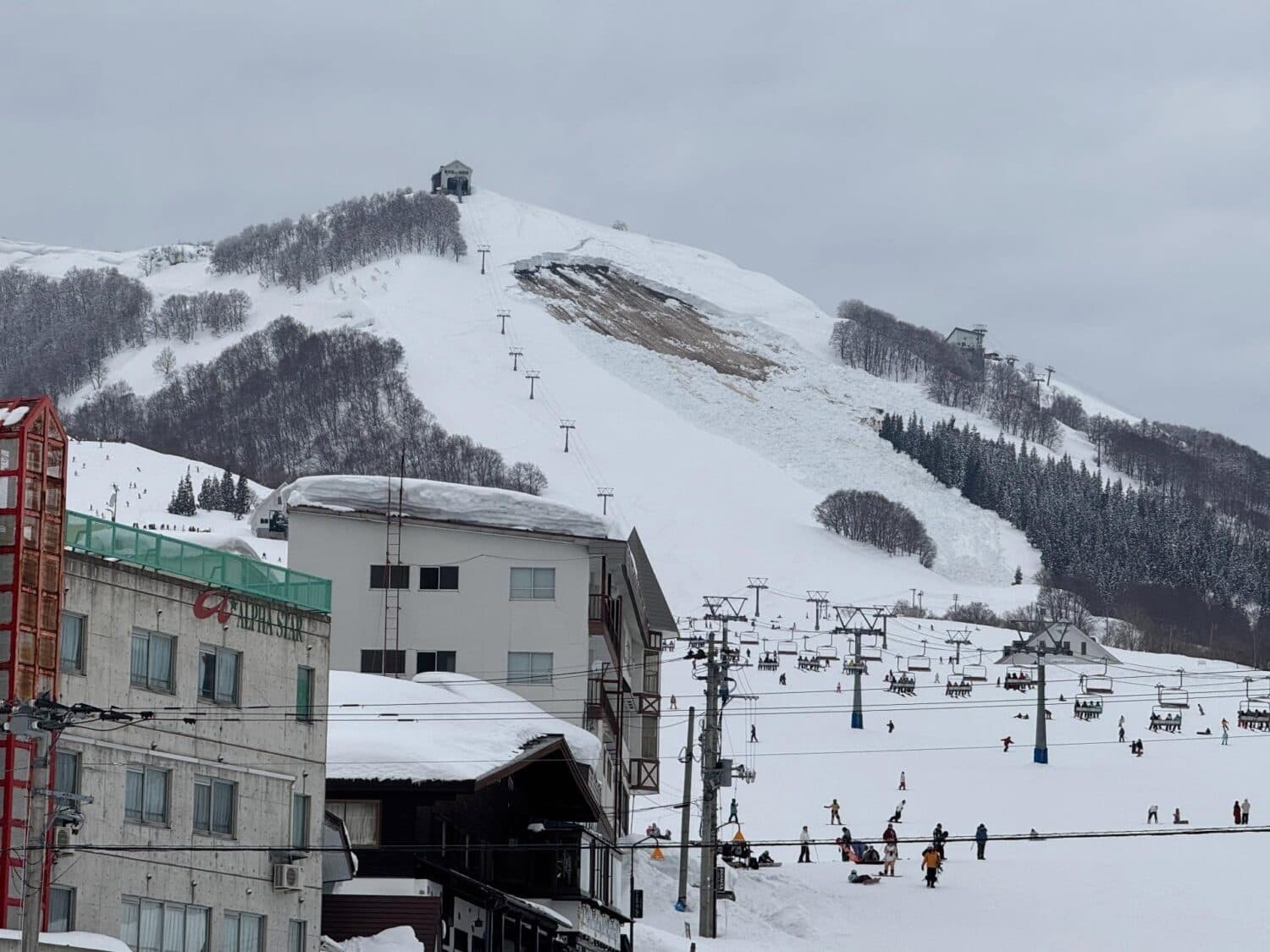 Iwappara in Japan - a ski lift going up a snowy hill.