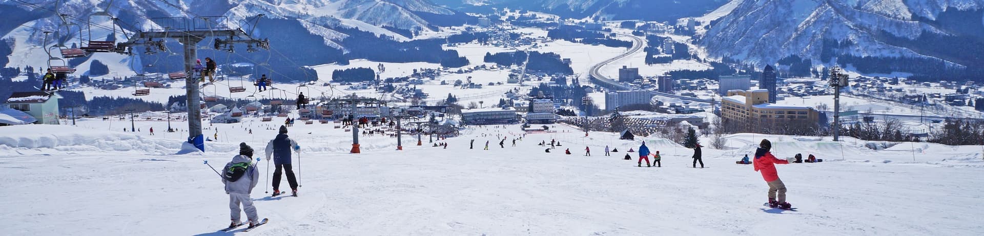 Iwappara in Japan - a group of people skiing down a snow covered mountain.