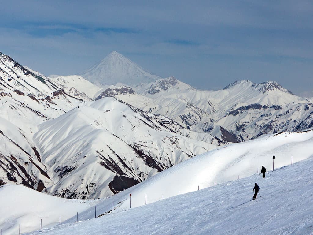Dizin International in Iran - a person skiing down a snowy mountain.